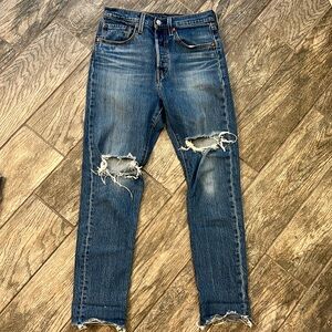 Levi’s 501 Skinny Jean with rip and bottom detailing. size 26